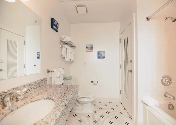 Experience Luxury At Captain Suite 219 In Bay Harbor, Mi, Featuring A Cozy Bedroom And Village View.